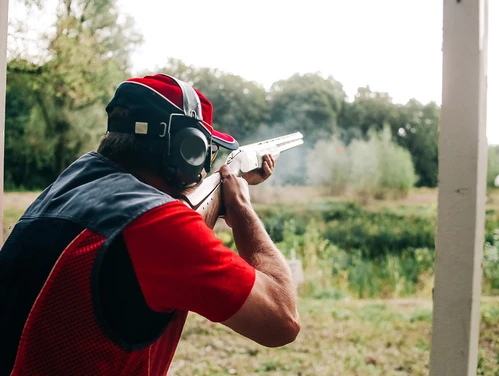Someone taking a practice shot at a range.