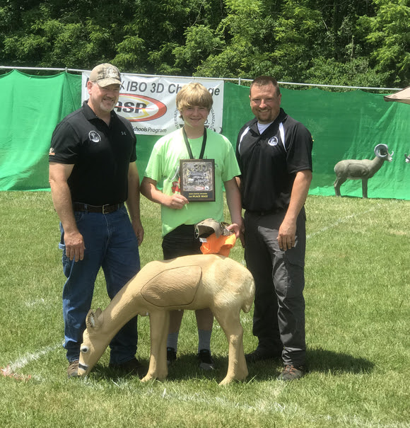 Logan Kelly, (center) from Mount Vernon, scored the first perfect round in a national 3D archery competition. Kelly is joined by Bryan Marcum, IBO president (left) and Ryan Bass, with the IBO 3D Challenge (right).