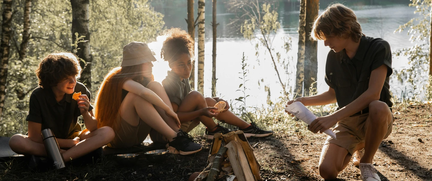 Students learning outdoors by a lake